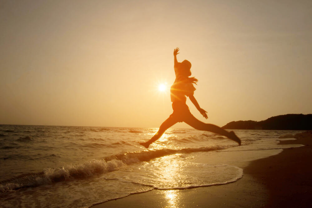 silhouette-woman-jumping-sea-sunset silhouette-woman-jumping-sea-sunset